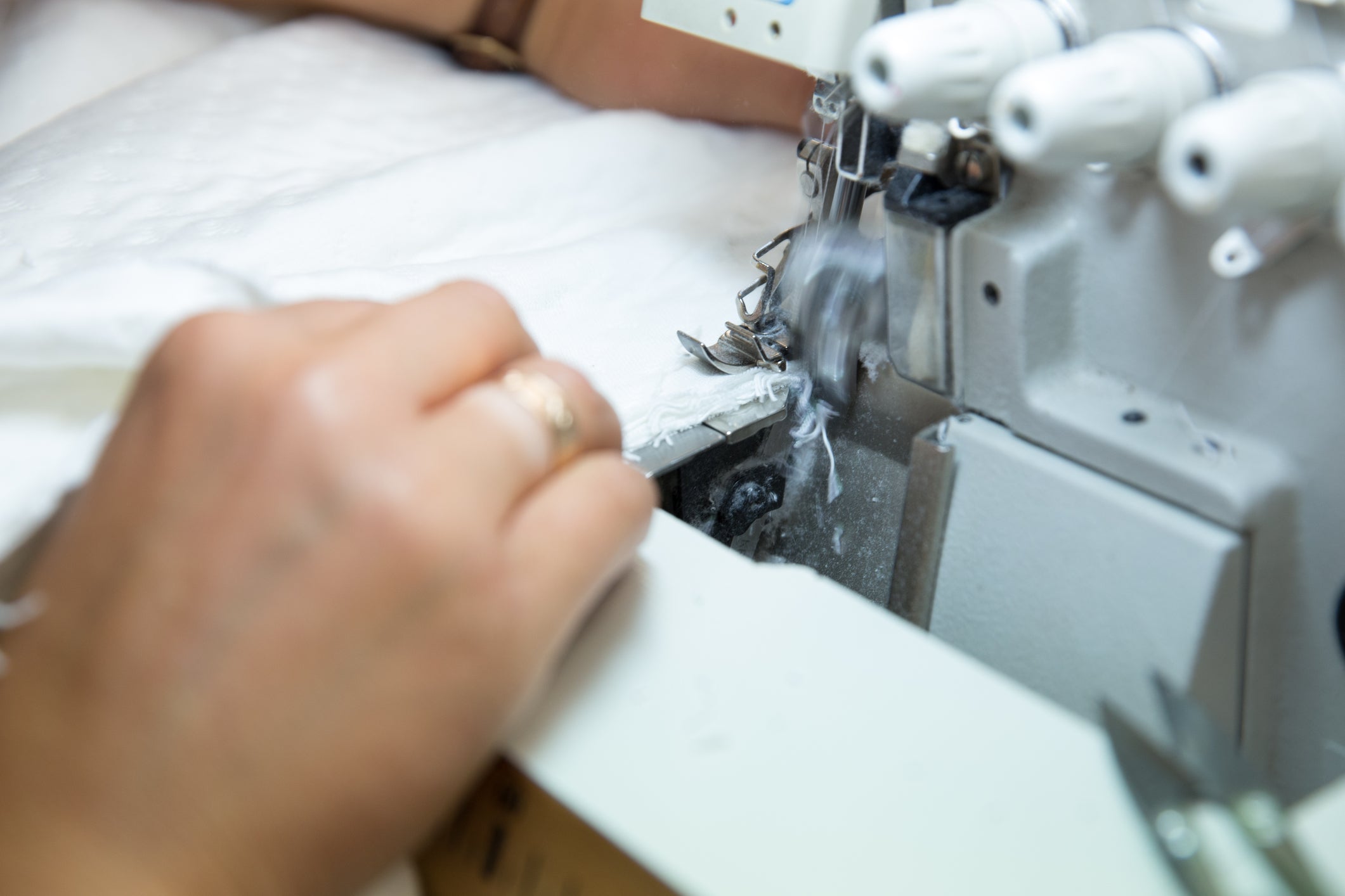 Person sewing mattress fabric