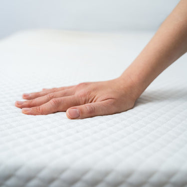 Hand on mattress