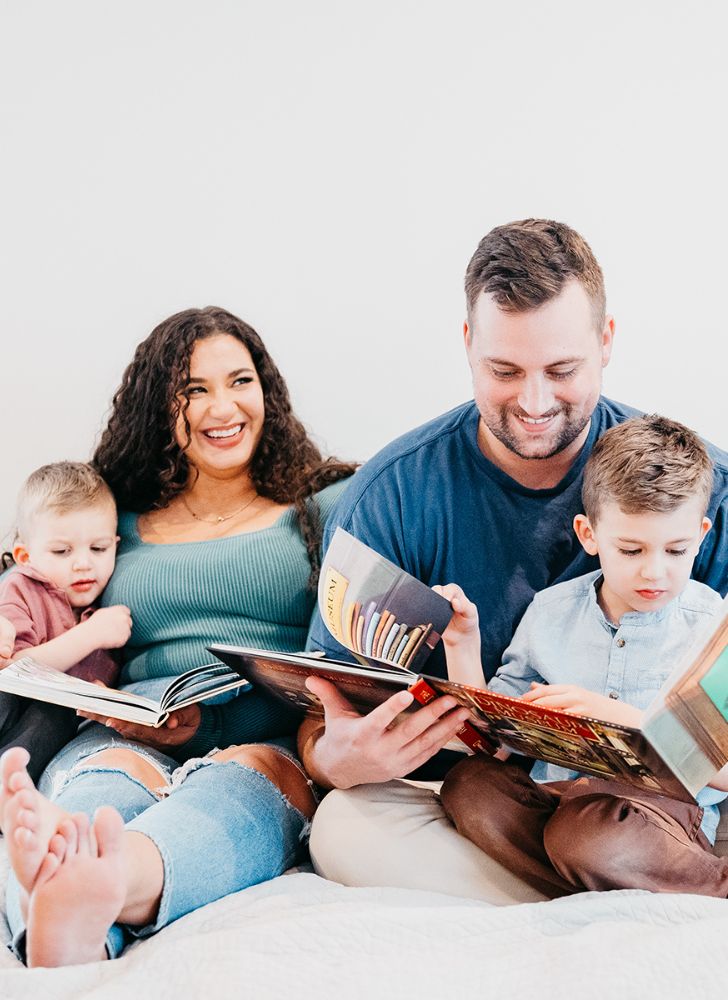 Megan from NC Eat & Play and her family reading on a MattressGrove mattress